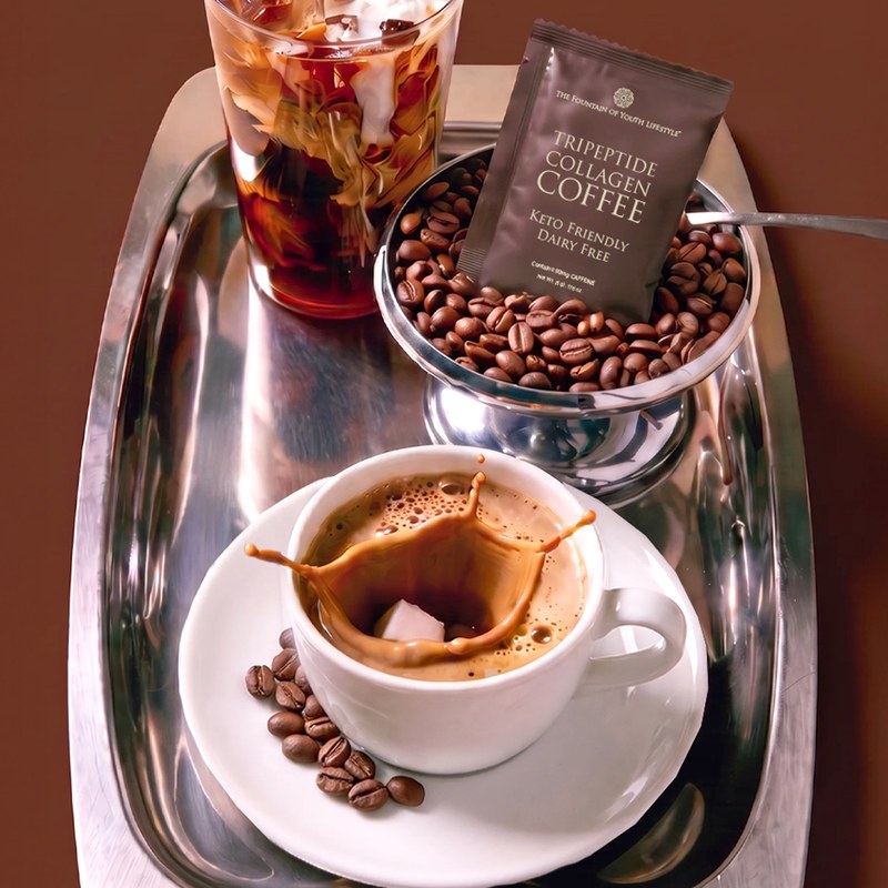 A Tripeptide Collagen Coffee sachet beside an espresso and coffee beans on a silver tray